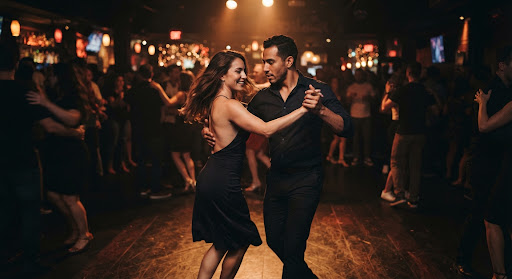 Couples dancing ballroom, salsa and swing in a brightly lit elegant contemporary studio ballroom